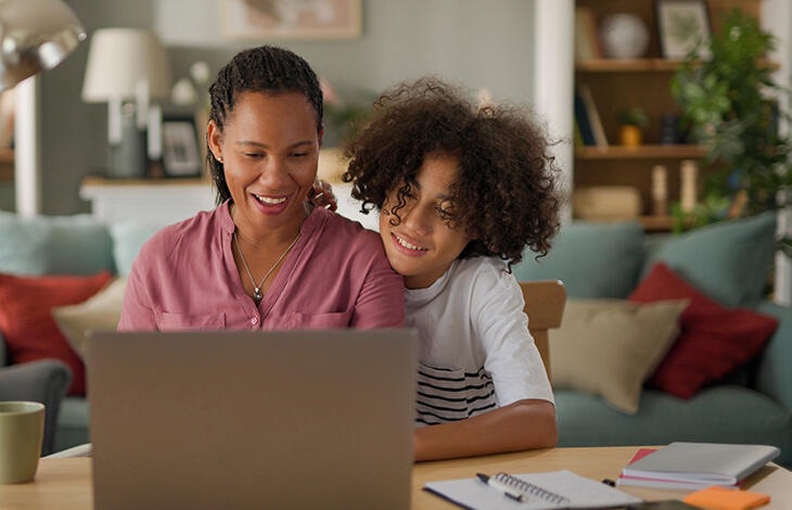 Mother and her child looking at a laptop