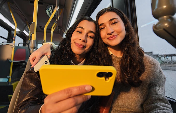 A person looking at their cell phone on a bus