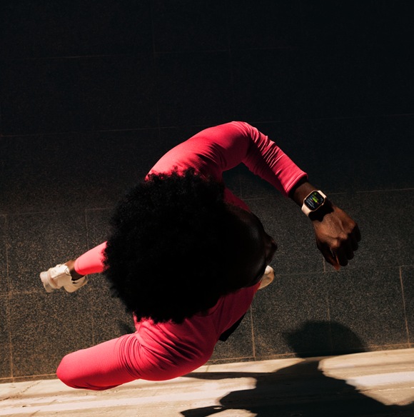 A person checks progress on Apple Watch Series 11 Workout app while running