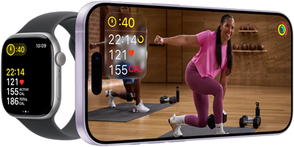 Apple Watch next to iPhone with Apple Fitness+ class on screen