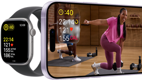 Apple Watch next to iPhone with Apple Fitness+ class on screen