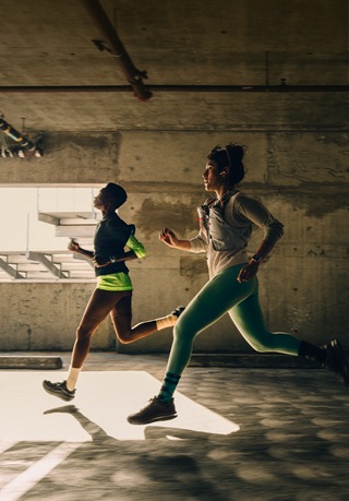 A group of people running in a city while wearing Apple Watch Series 12