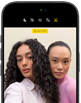 iPhone 18 Pro, black, front exterior, displaying two models posing for the camera, demonstrating the Center Stage front camera