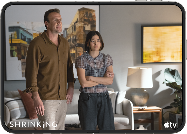 iPhone Duo, opened in horizontal position, Apple TV show "Shrinking" plays on screen